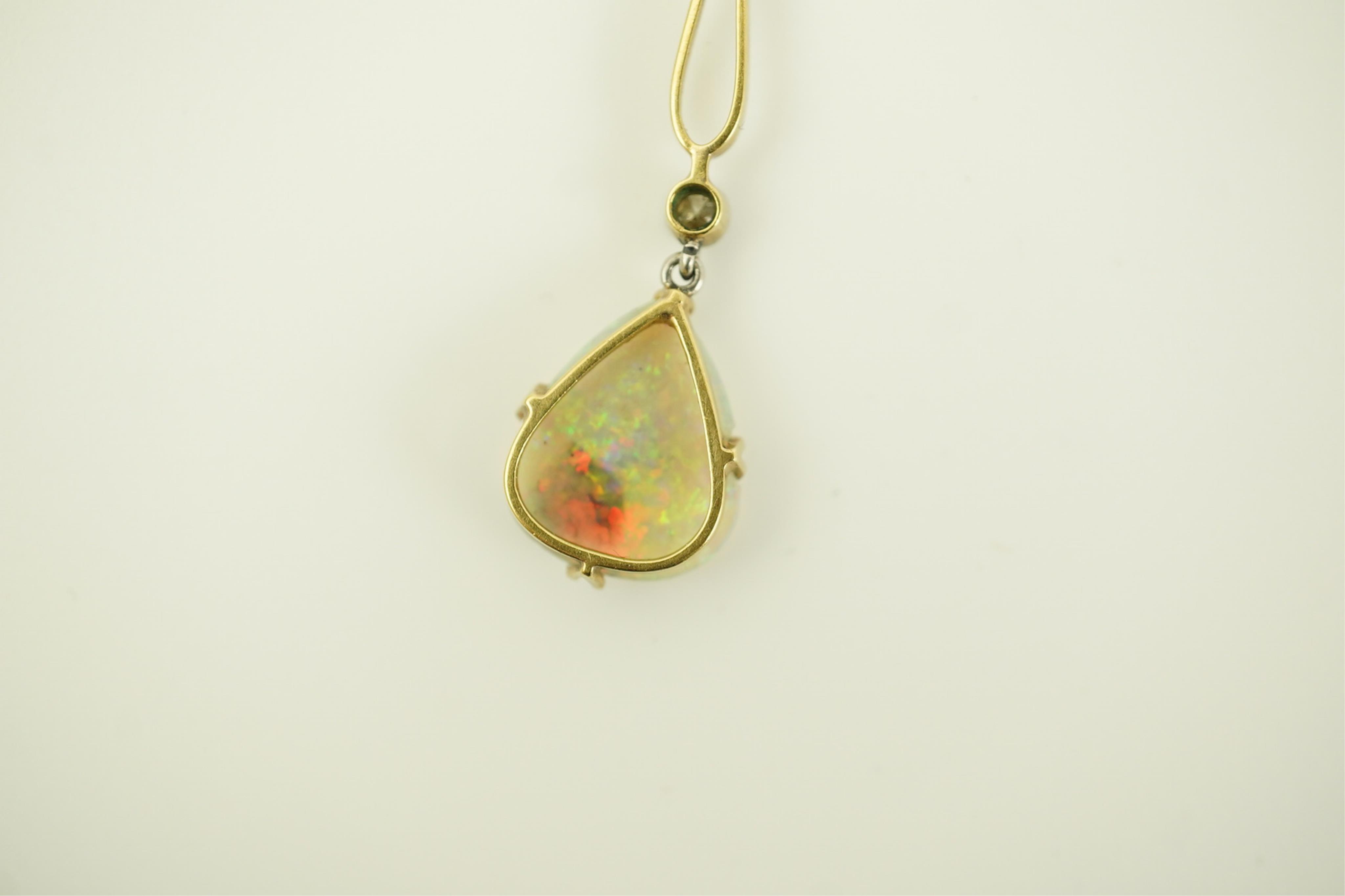 An early 20th century gold, two stone white opal and single stone diamond set drop pendant necklace